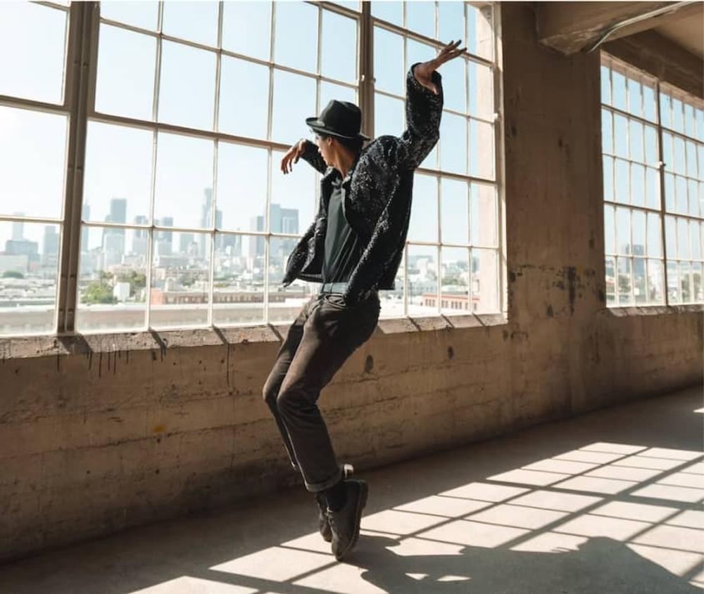 Dance performer in front of a window