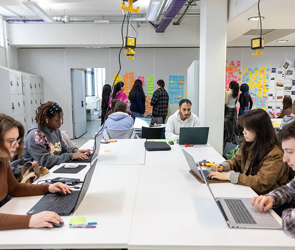 Graphic design students working around desk