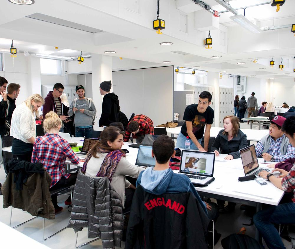 A group of graphic design students in their studio