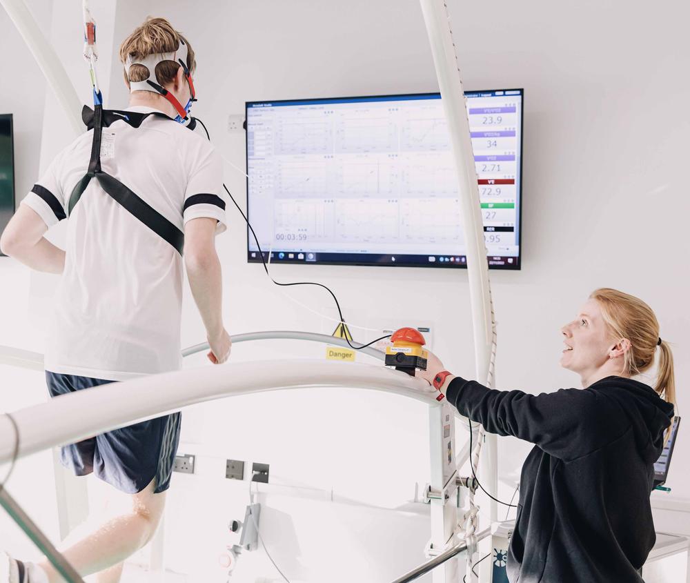 Sports students completing performance analysis using a treadmill