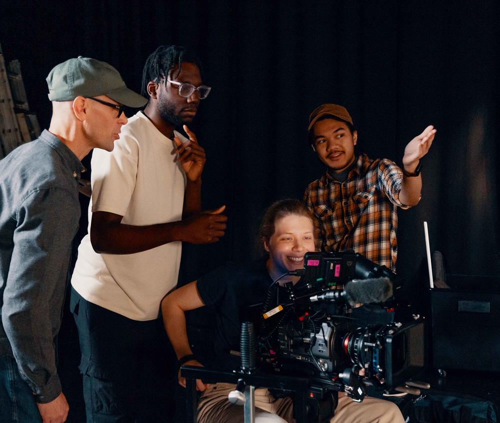 Film students and lecturer behind the camera