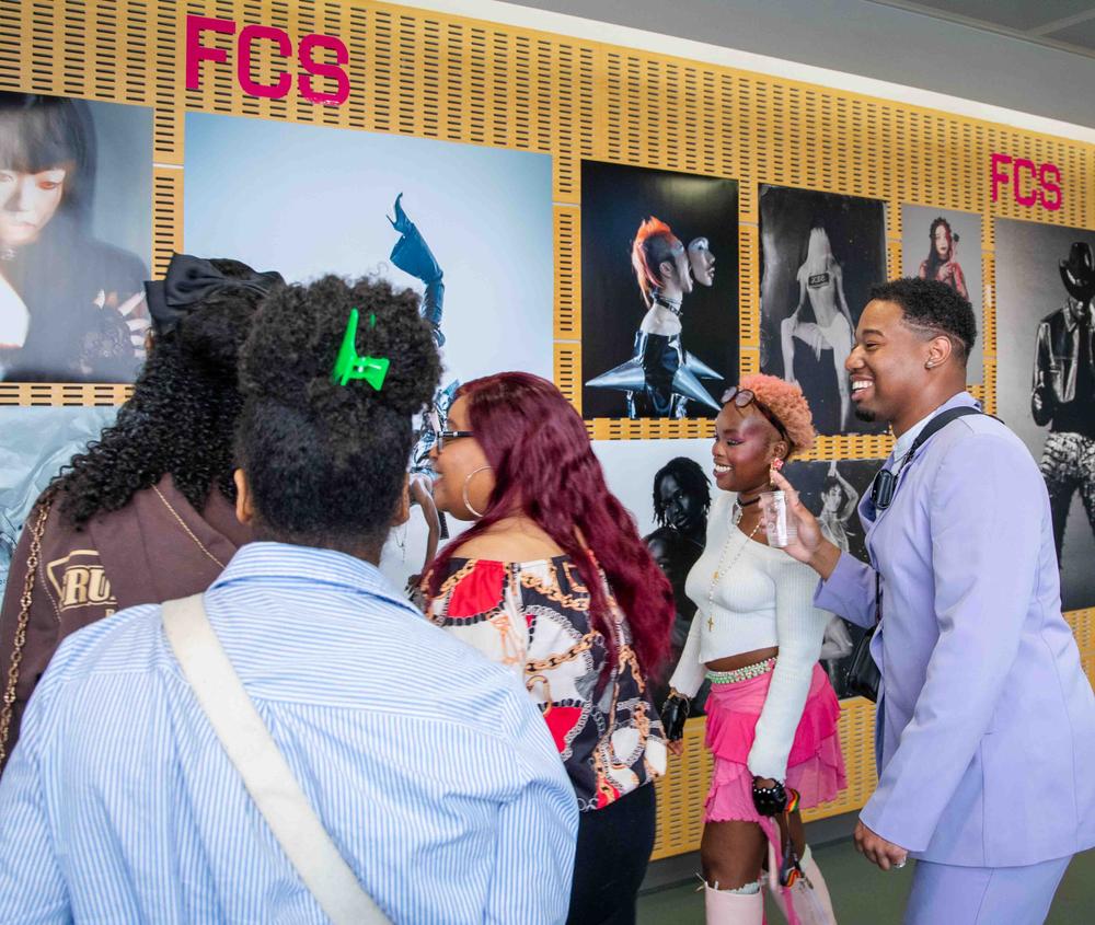 A group of people looking at an art exhibition