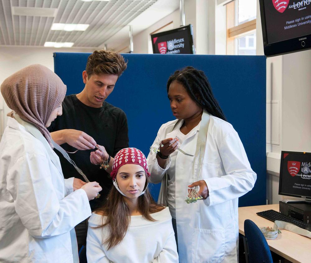 Students putting sensors onto another students head