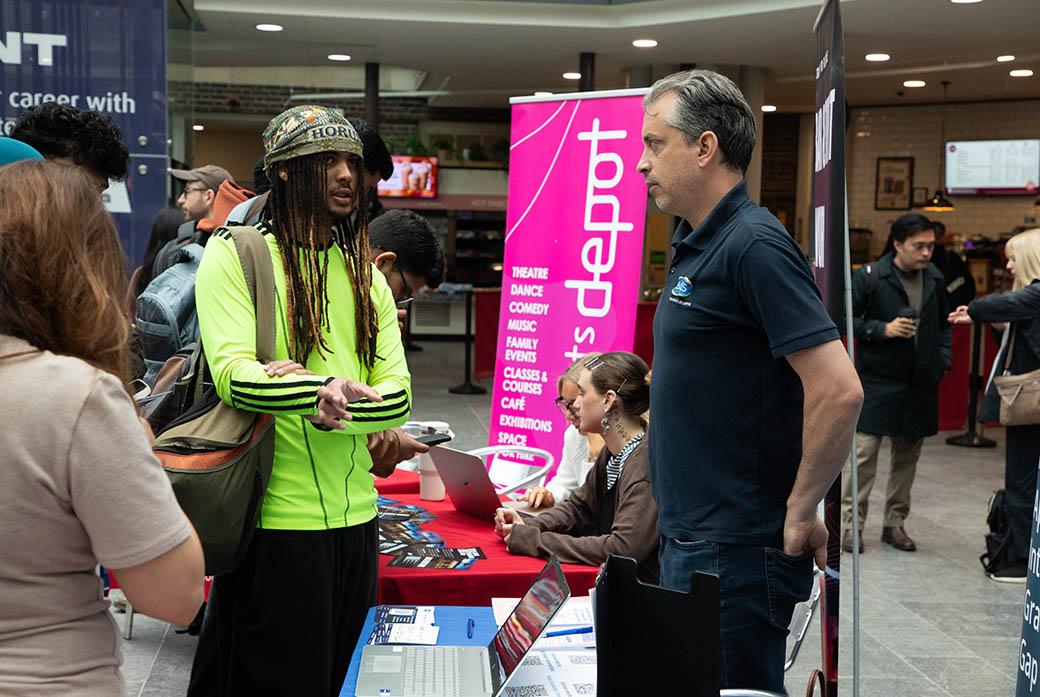Students speaks with employer at university event