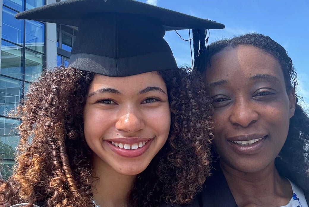 A student graduate poses for photo