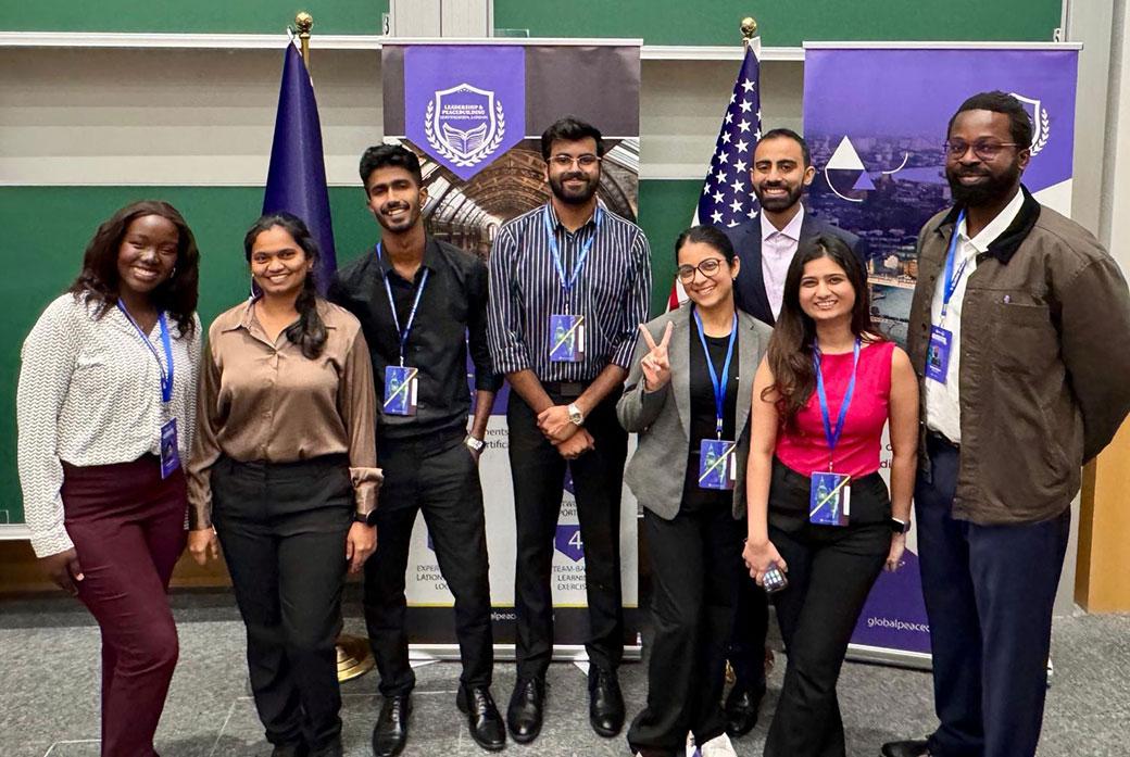 Students stand together for photo after conference