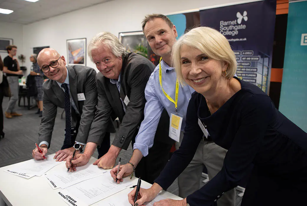 People sign paper in a studios
