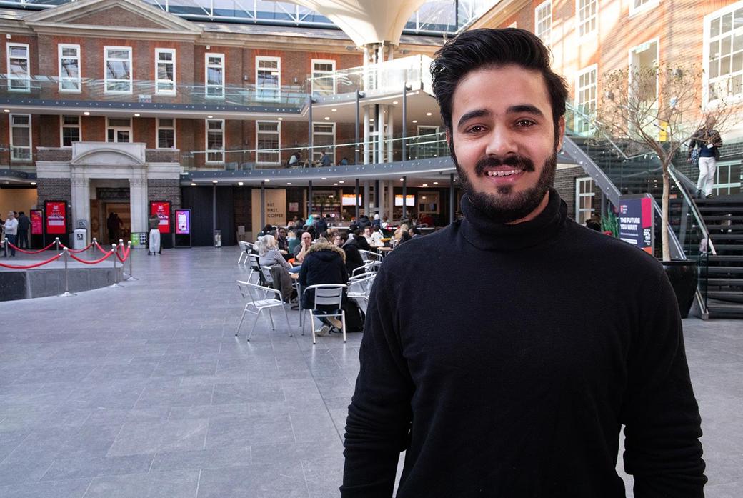 Male student in the quad building at Middlesex University