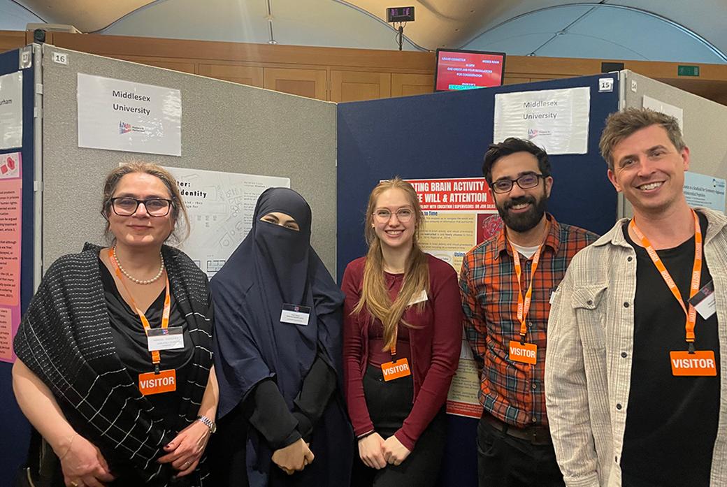 Five people standing and smiling at the camera