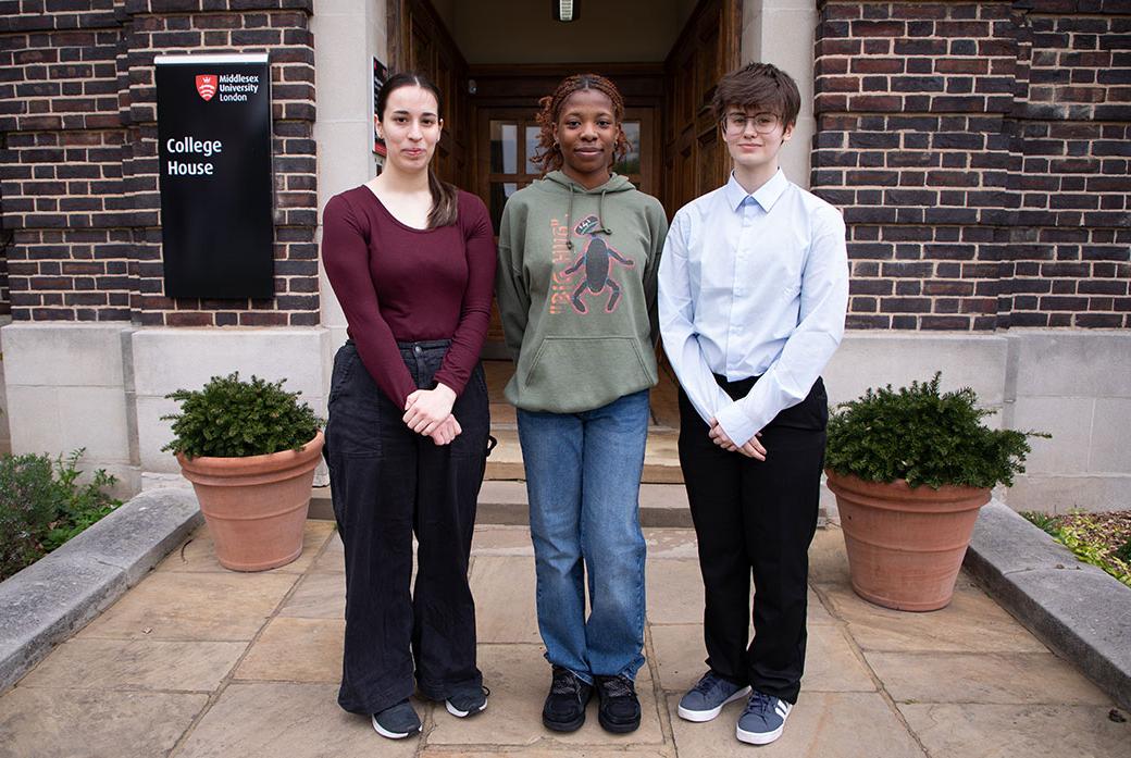 Students stand outside a building on campus