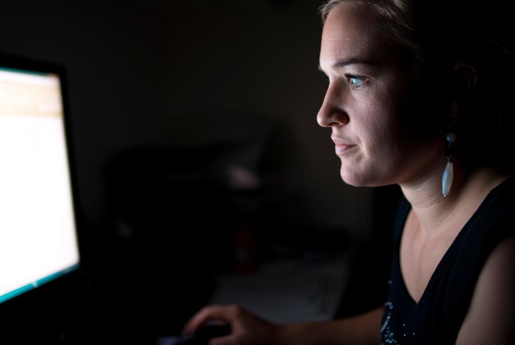 woman reading something from a computer screen