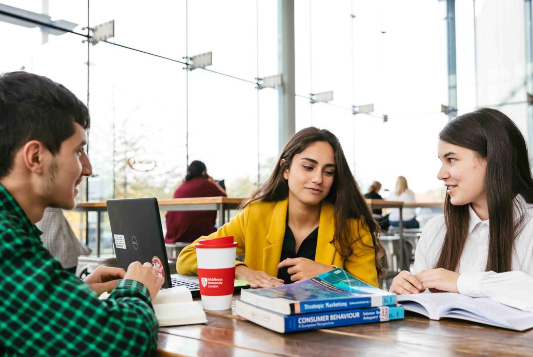 Three Business students working in a cafe