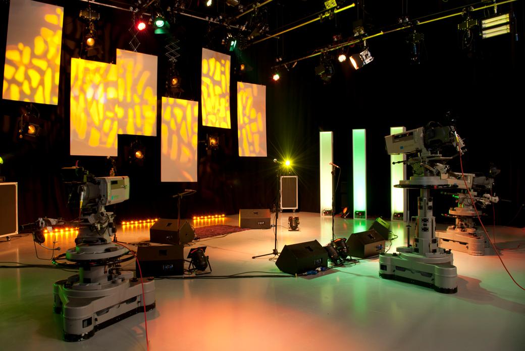 a TV studio with two large cameras and a studio backdrop