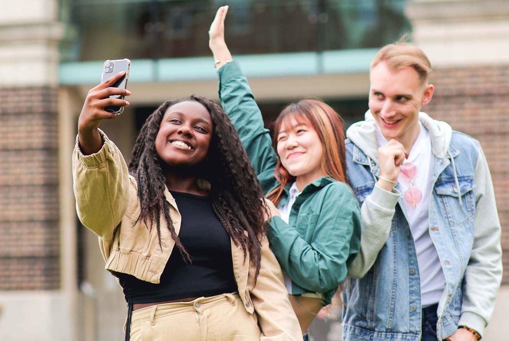 Three students on campus taking a selfie
