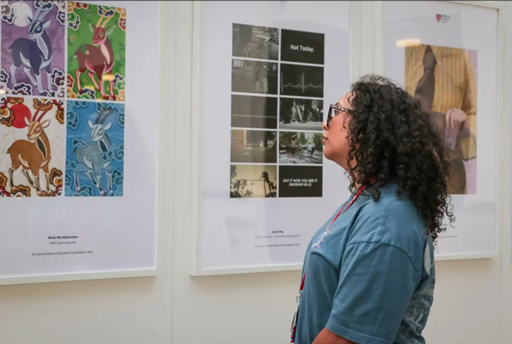 Young woman viewing artwork.