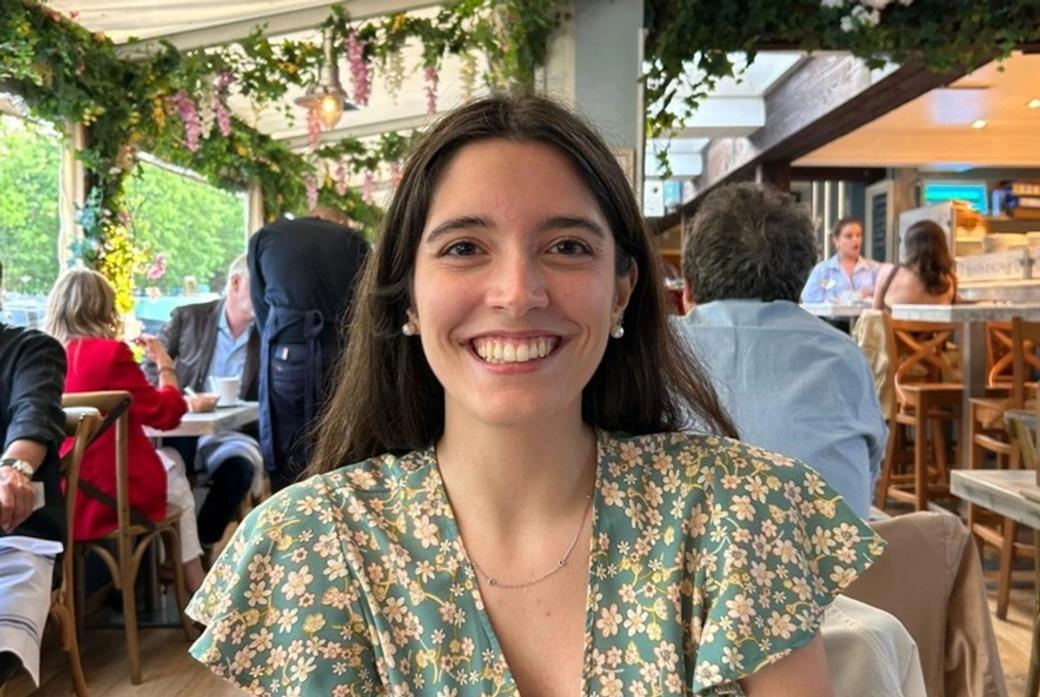 Arianna Magnanini smiling and sitting at a restaurant table