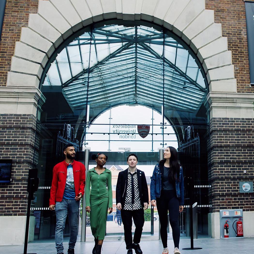 Four students walking through the Hendon campus