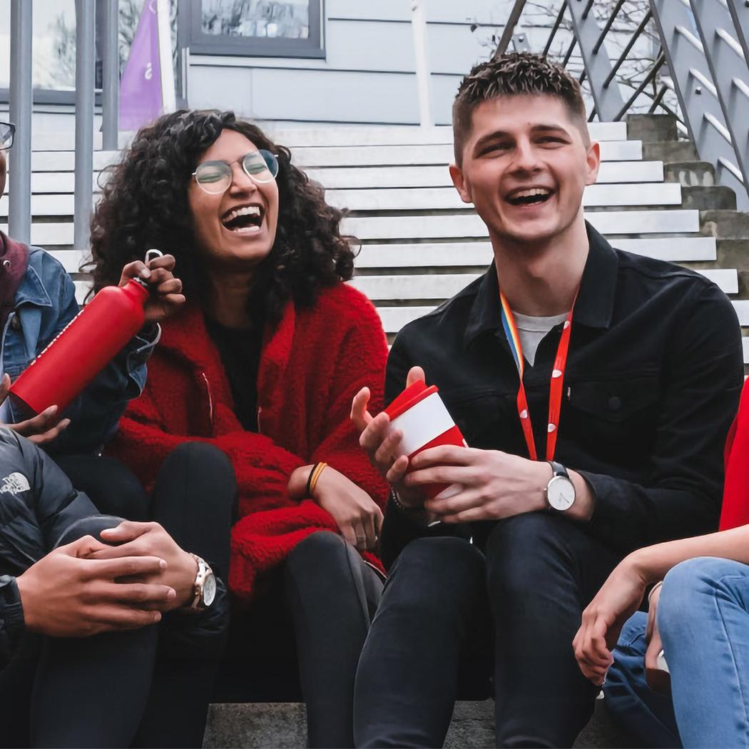 Group of students sits on steps