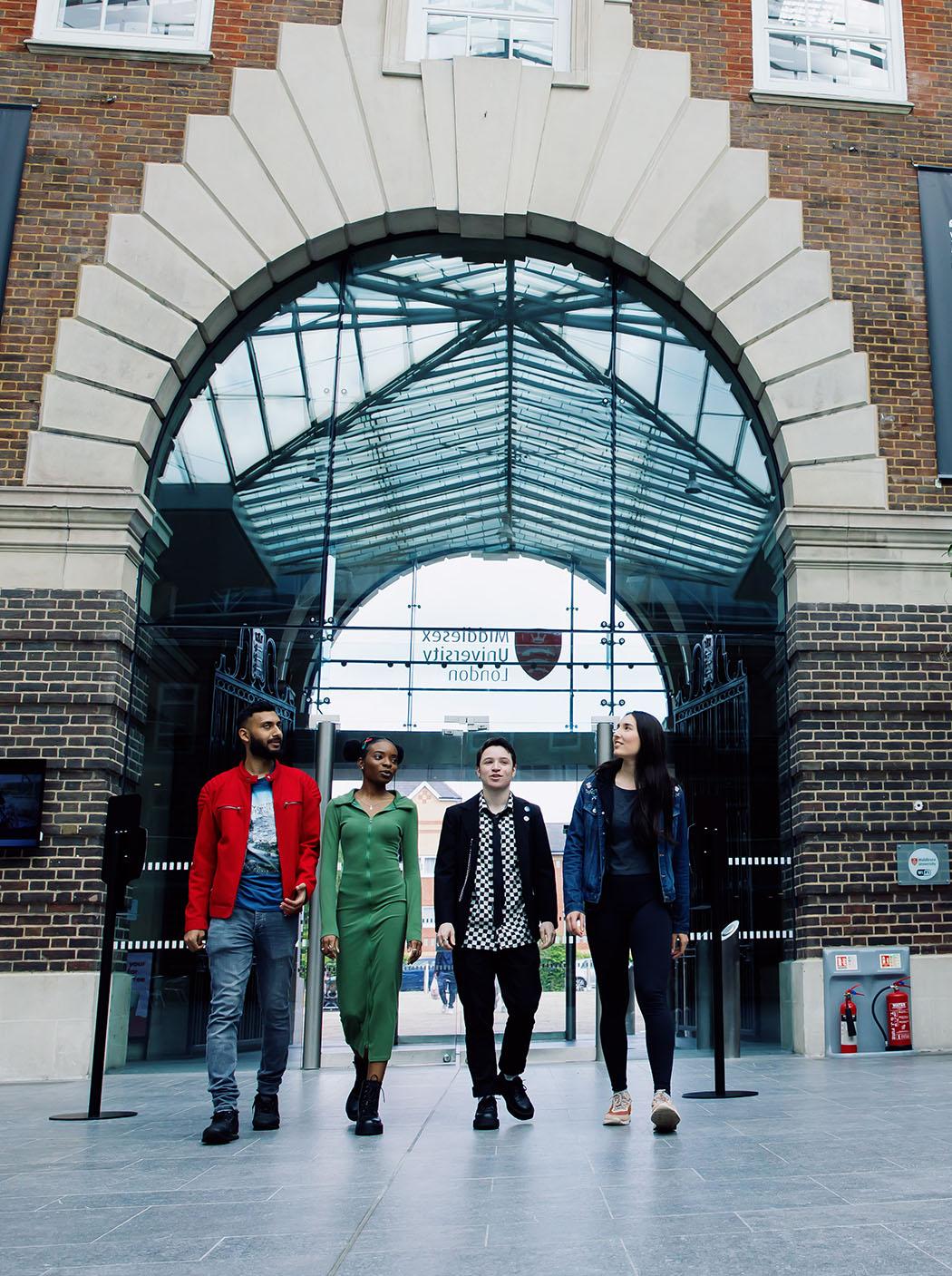 Four students walking through the Hendon campus