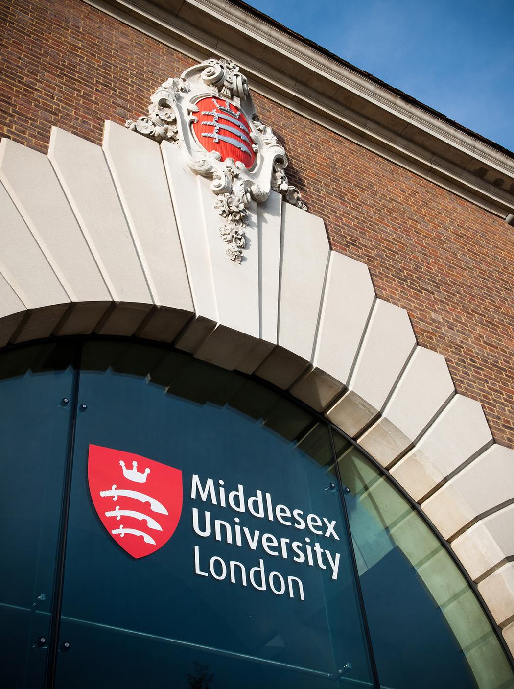 Outside of brick building, with arch and Middlesex University logo
