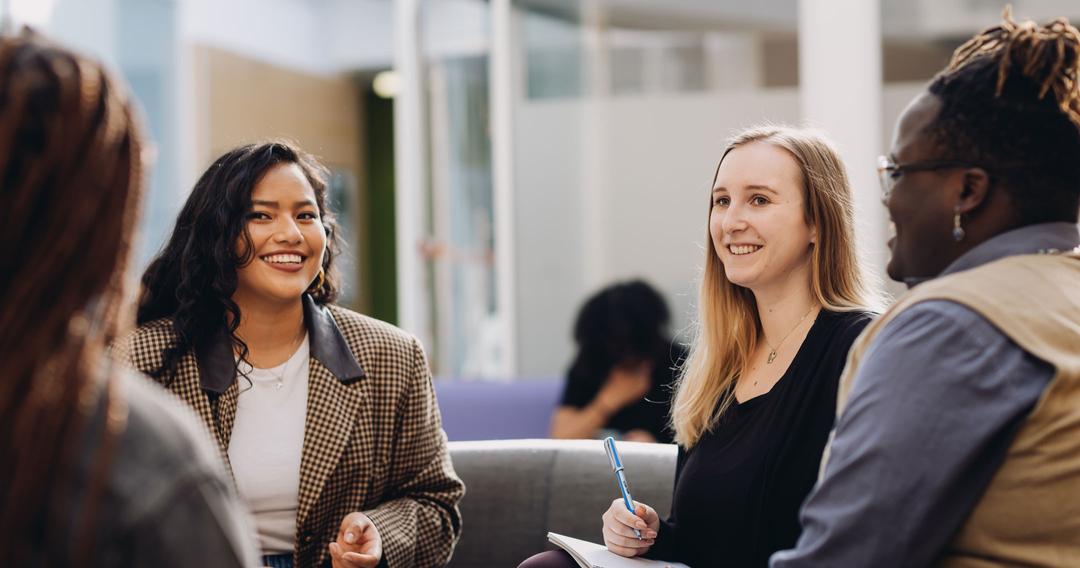 Group of marketing students chatting in a circle