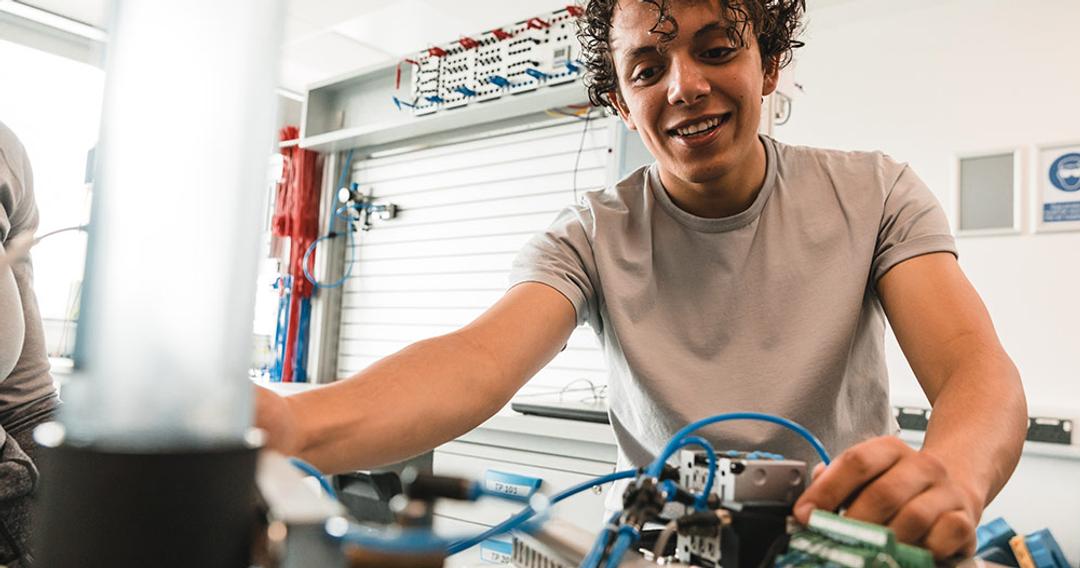 Robotics student working on a project