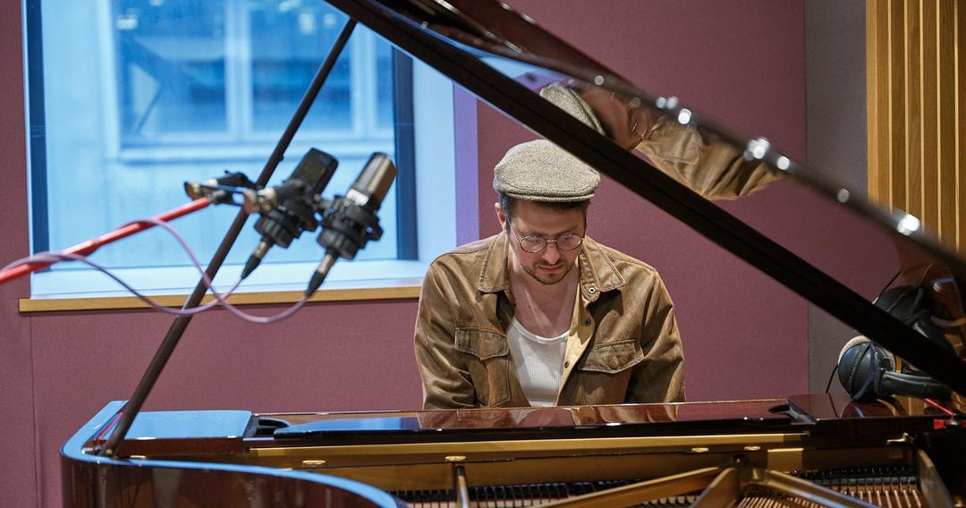 Music production set up alongside speakers and headphones