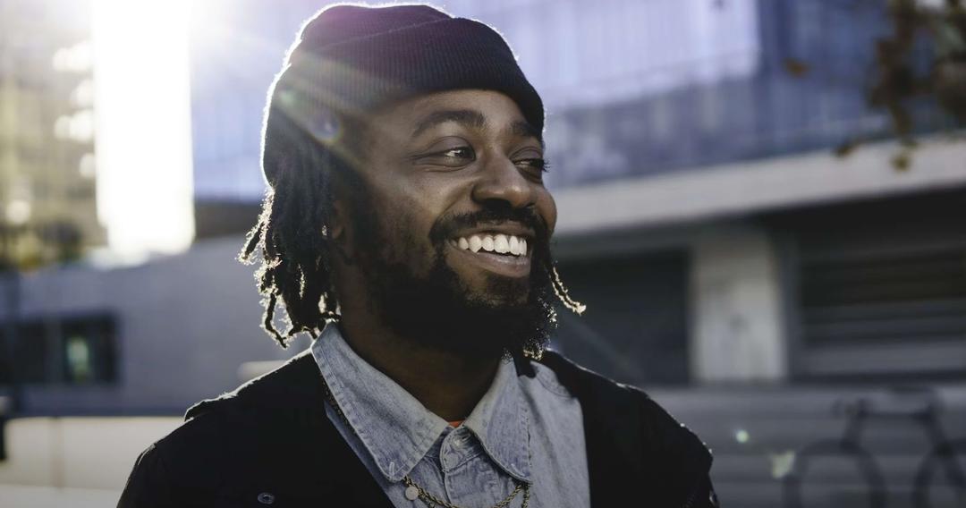 Person smiling wearing a hat
