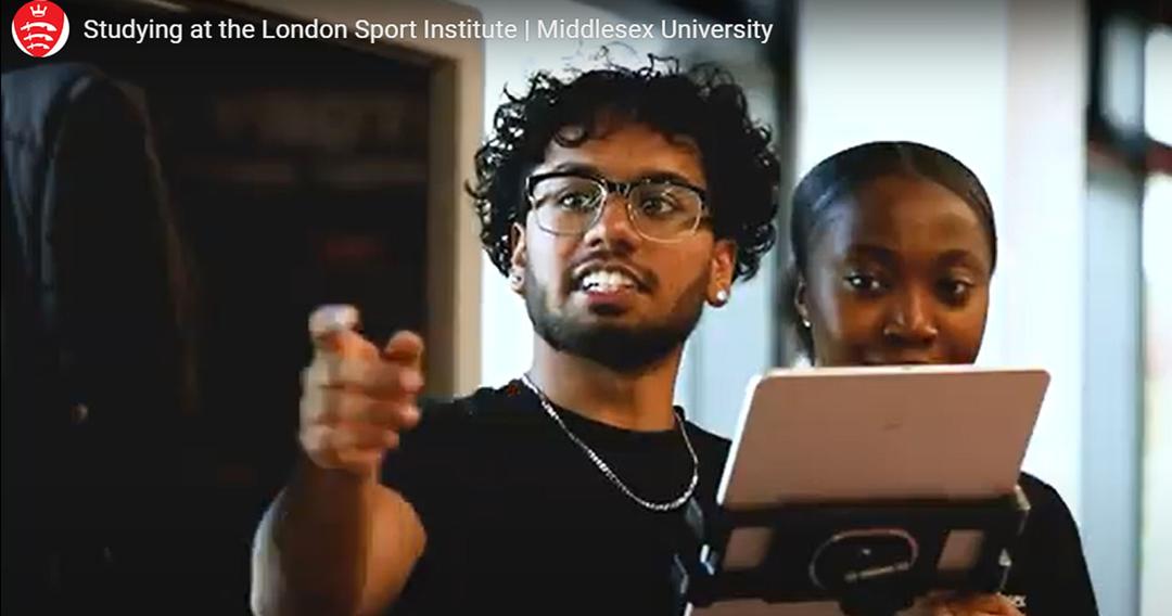 two students working on some sports science equipment