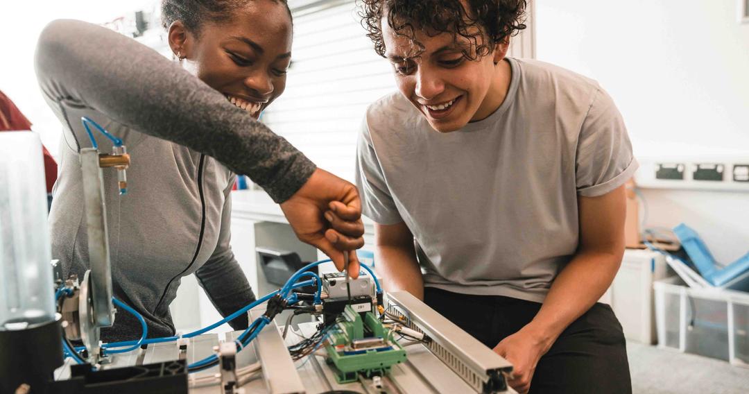Two students working on a robotics project