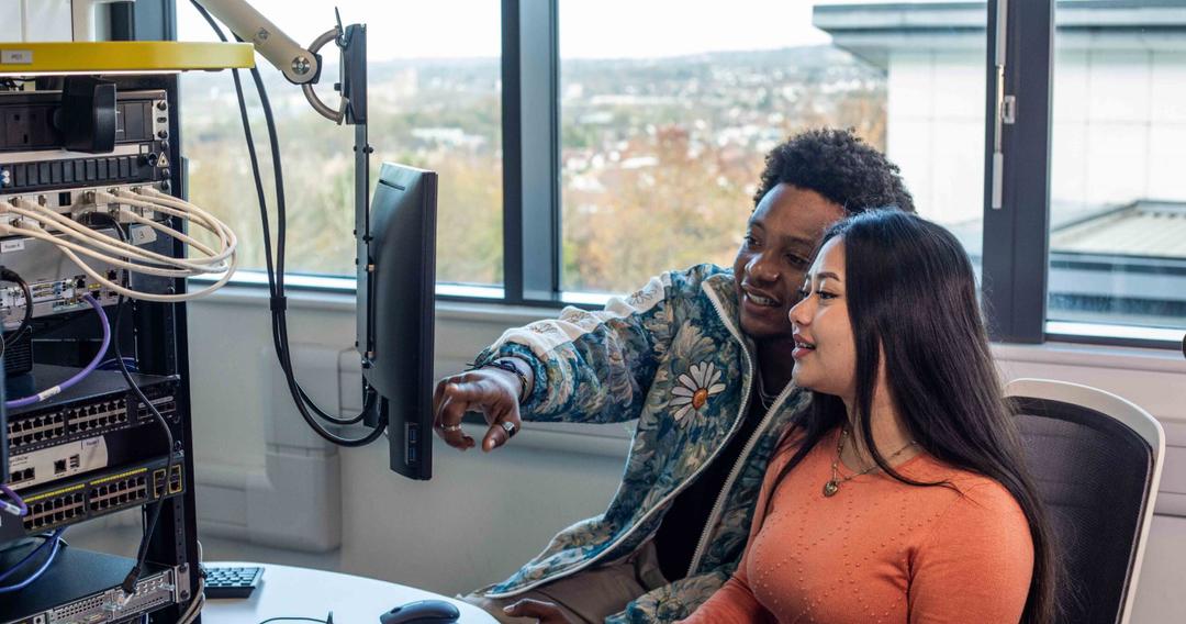 Two computer science students working in the lab