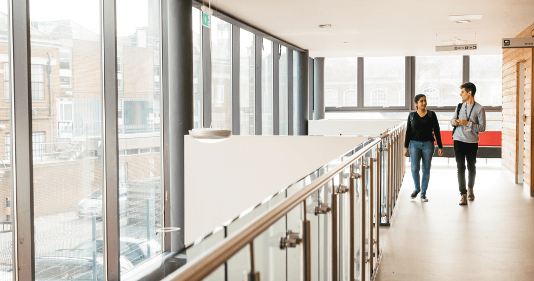 Students walking and talking in the first floor of the Hatchcroft building