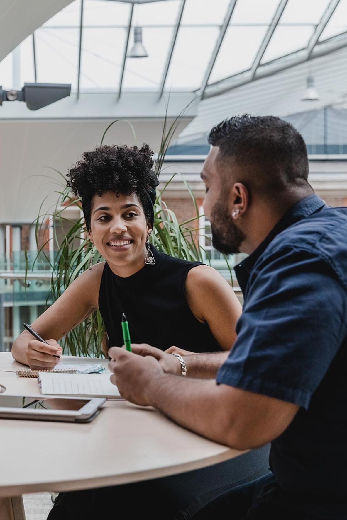 Two students chatting in communal area at Middlesex University
