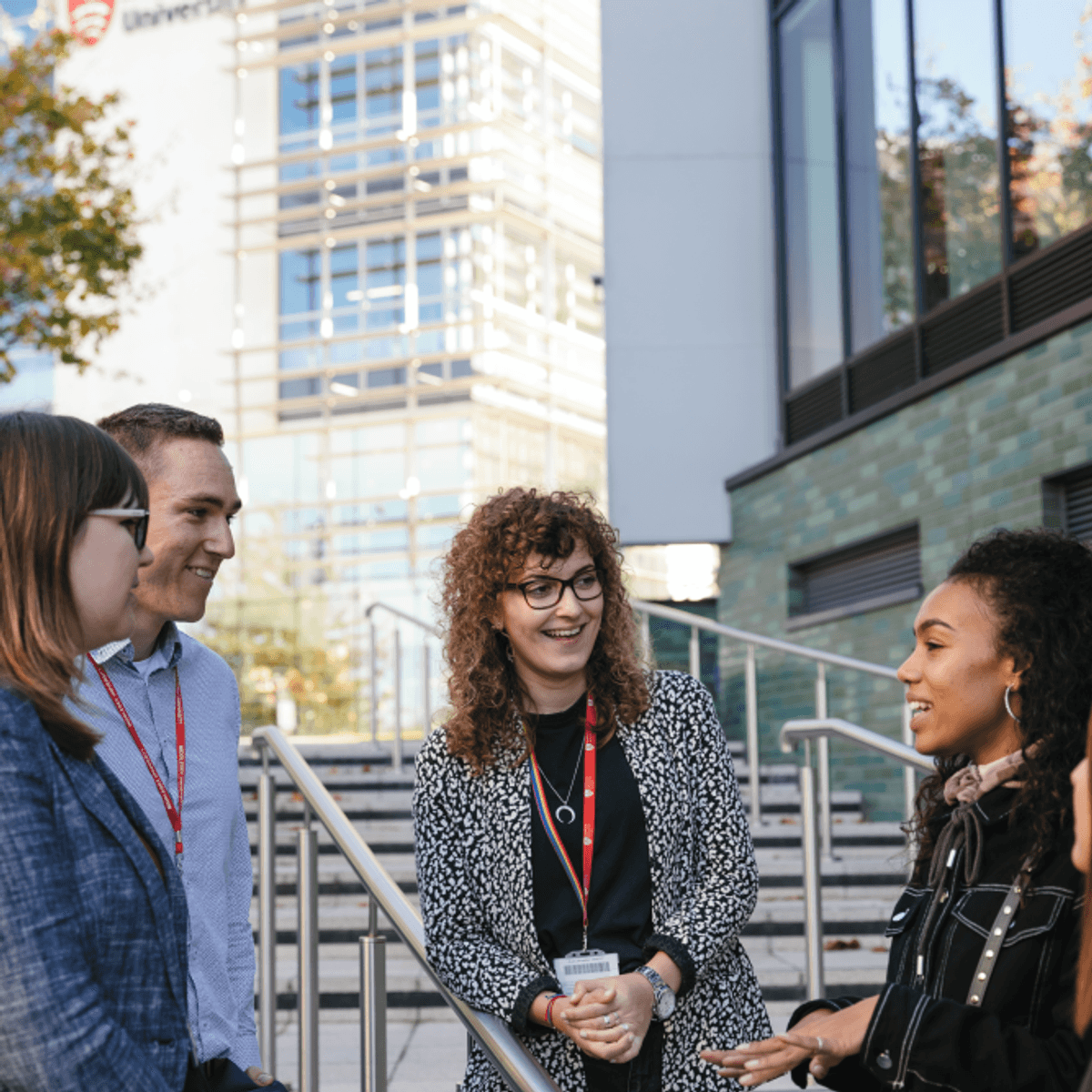 Staff and students talking outside the Ritterman building