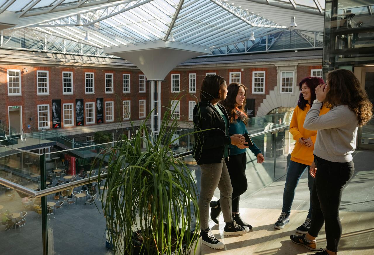 Group of students on the first floor of a red brick building