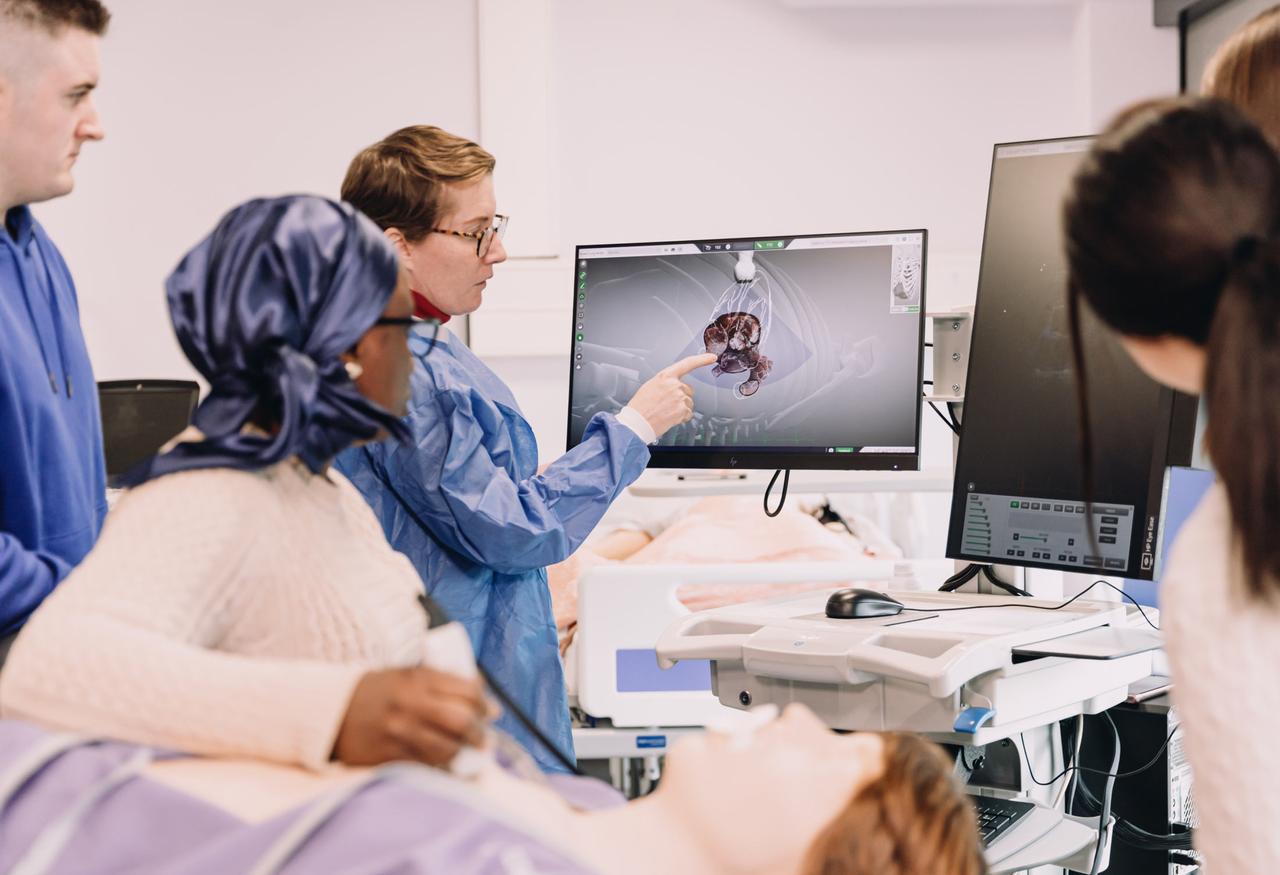 Students examining a patient scan.