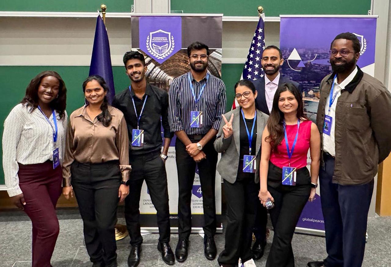 Students stand together for photo after conference