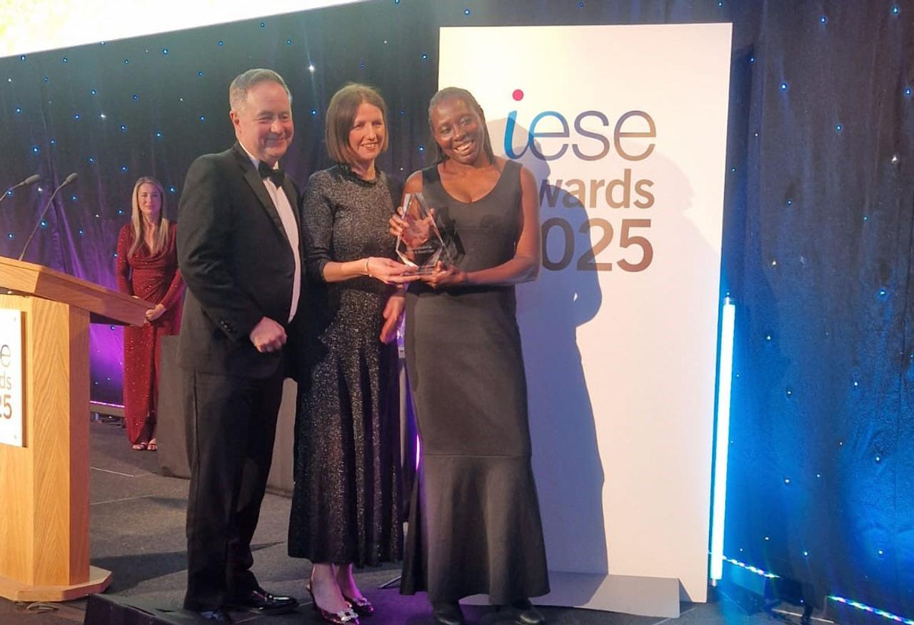 one man and two women receiving an award