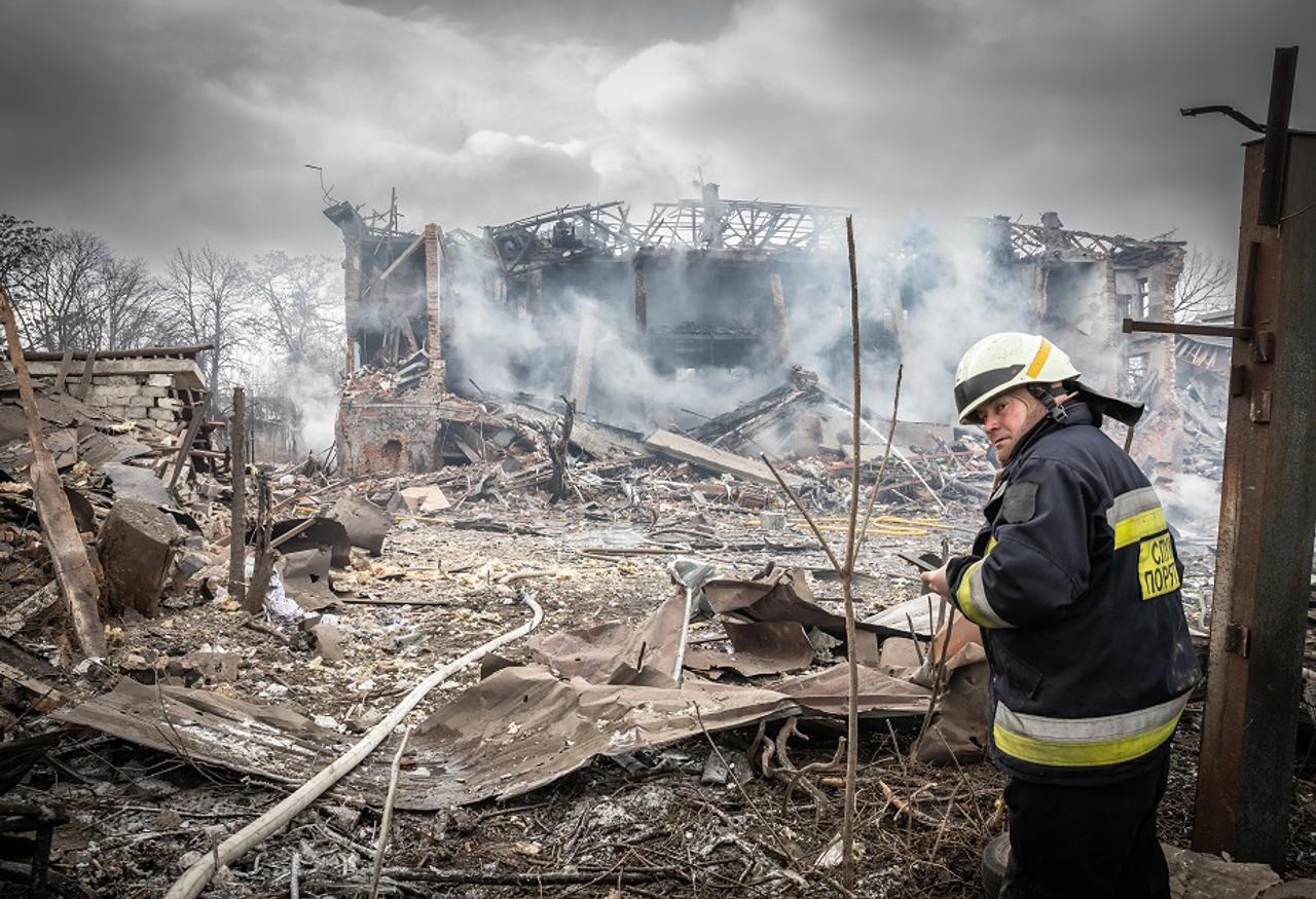 A worker is looking at a scene from Ukraine War