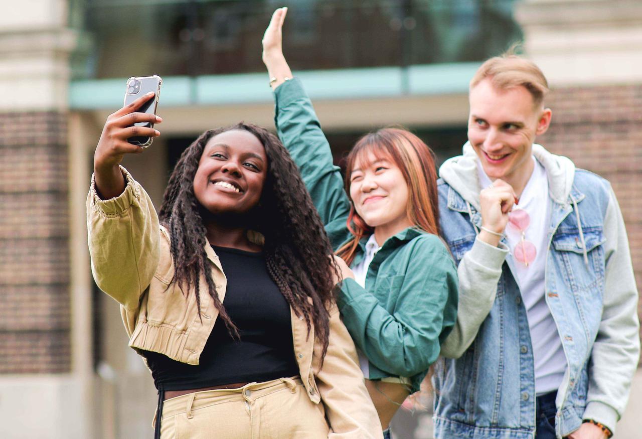 Three students on campus taking a selfie
