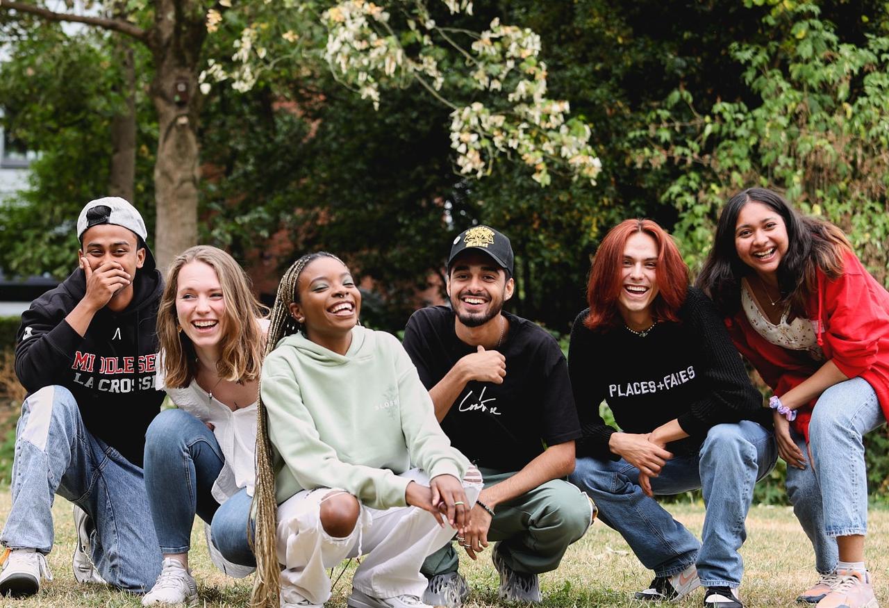 A group of young people smiling and posing together for a photograph, capturing a moment of camaraderie and friendship.