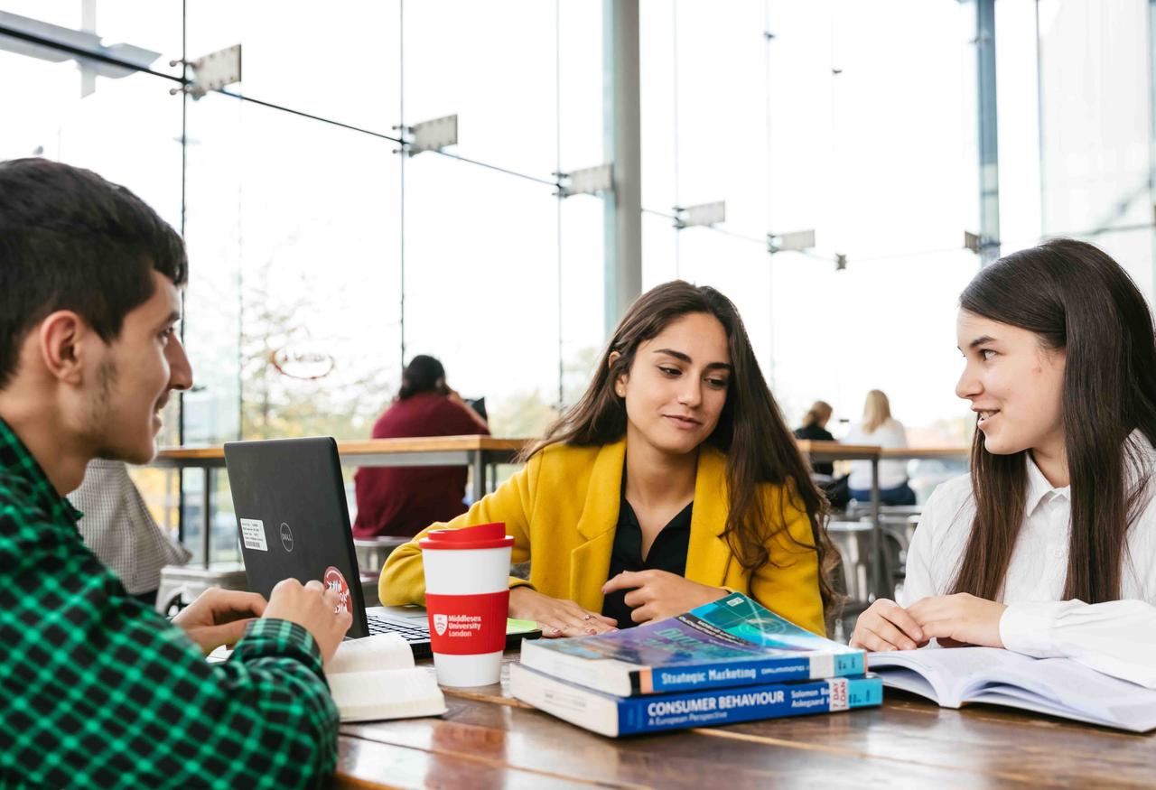 Three Business students working in a cafe