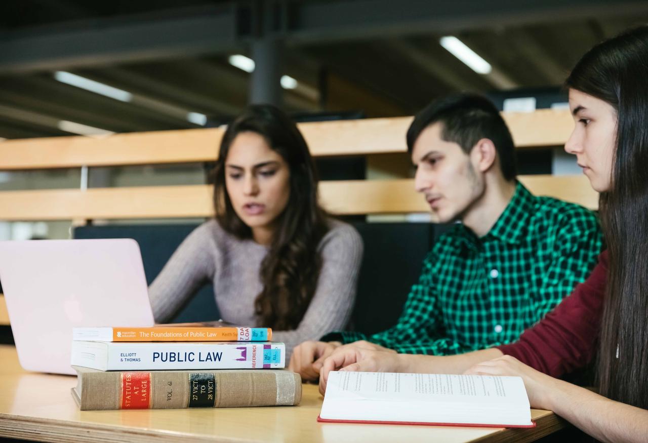 Law students studying together with their laptop and law books
