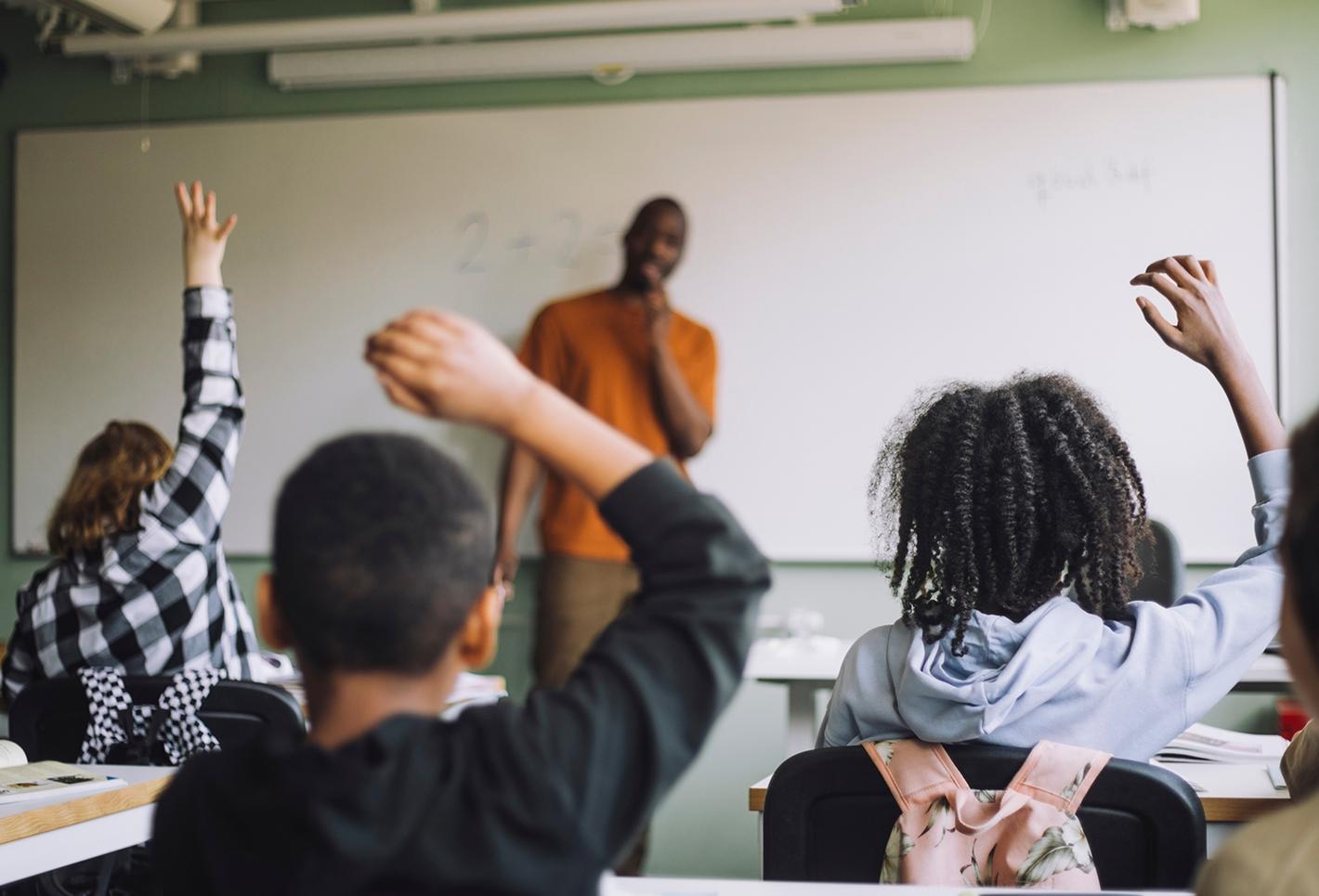 Teenagers in classroom with teacher
