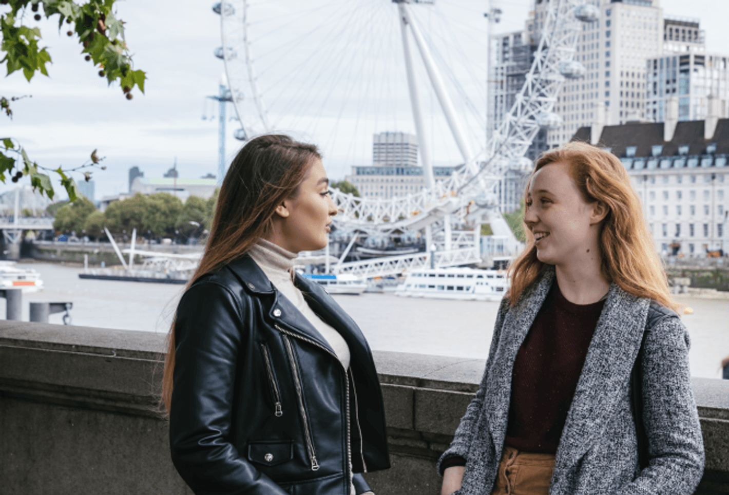 students by the river Thames, next to Westminster Bridge, London eye in the background