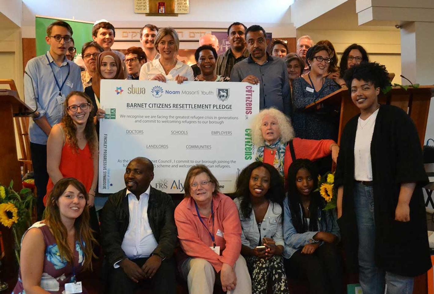 Students pose with the Barnet citizen resettlement pledge award
