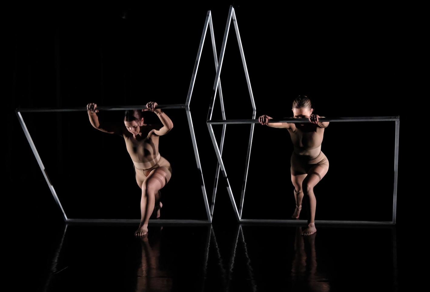 Two student dancers on a dark background