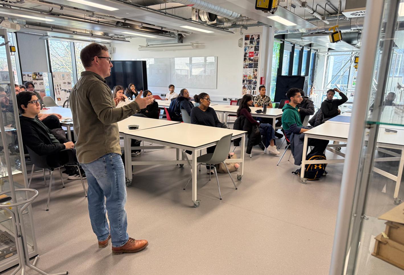 Students and a tutor in a computing classroom