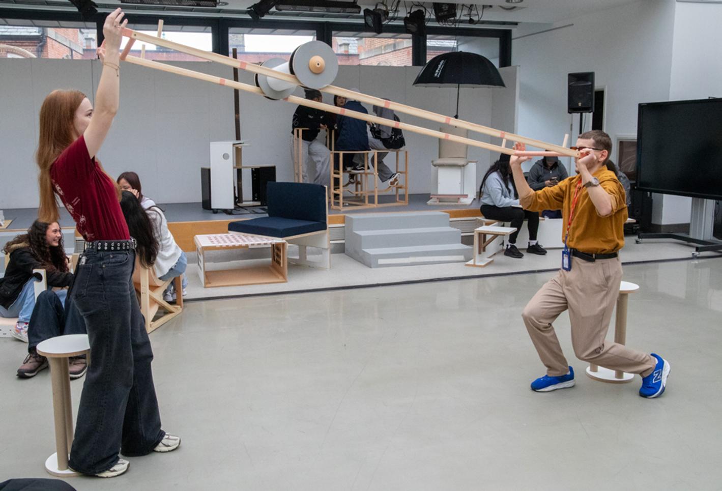 Two people interact with a roller in a studio