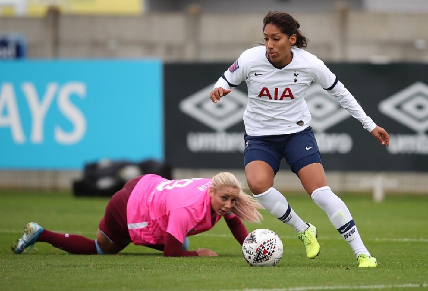 Female soccer players on the field.